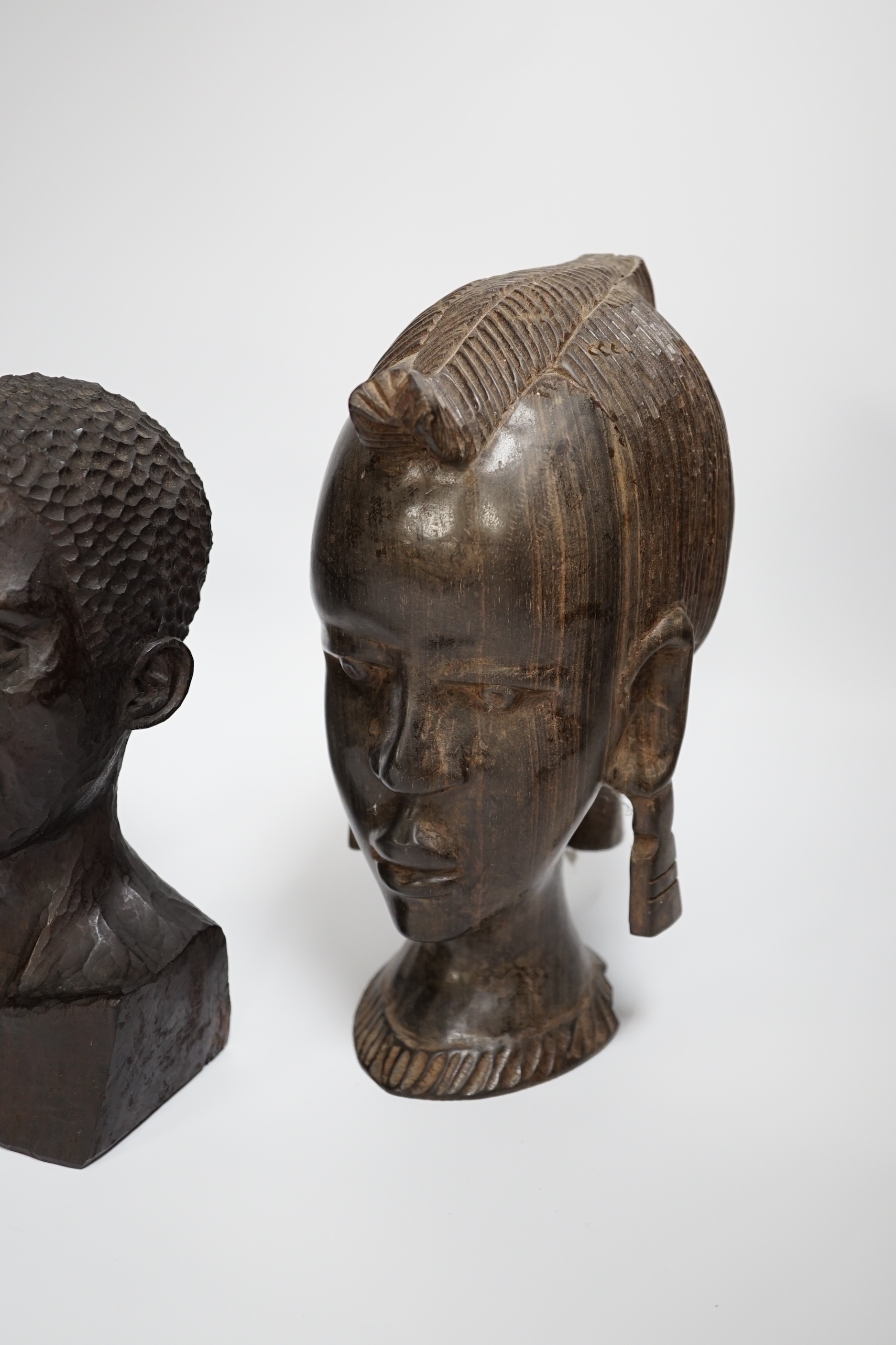 Three carved ebony African busts, tallest 23cm